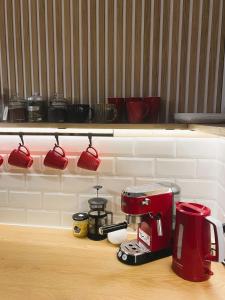 a kitchen counter with a red coffee maker and cups at SecondHomeViljandi Apartment in Viljandi +13 photos