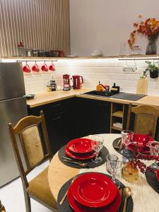a kitchen with a table with red plates on it at SecondHomeViljandi Apartment in Viljandi