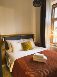 a bedroom with a large bed with two towels on it at SecondHomeViljandi Apartment in Viljandi +10 photos