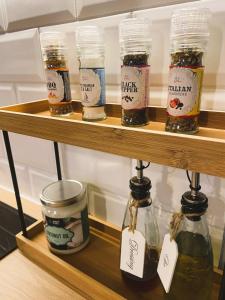 a shelf with jars of honey on it at SecondHomeViljandi Apartment in Viljandi
