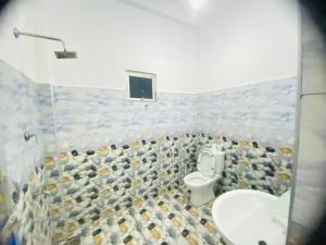 a bathroom with a toilet and a sink at Mount Top in Dickwella