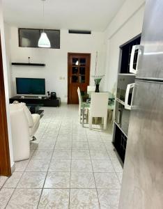 een keuken en woonkamer met een tafel en stoelen bij Maianga Flat in Luanda +4 foto's