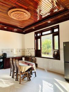 a kitchen with a table and chairs and a window at Nutty Village Phu Quoc in Phú Quốc