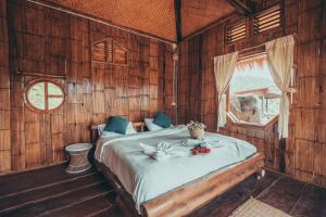 a bedroom with a bed in a wooden room at Lazy mango homestay in Ban Mae Sapok Nua