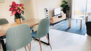 a living room with a wooden table and chairs at Apartment Fontana Golf Villamartin in Orihuela Costa