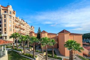 a row of palm trees in front of a building at Villas Elenite Premium in Elenite