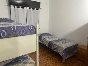 a bedroom with two bunk beds and a window at Maraja318X in Mar de Ajó