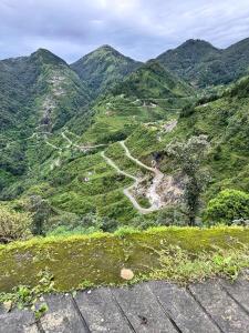 a view of a mountain with a dirt road at Bella Vista Hotel & Home Stay in Mussoorie +7 photos