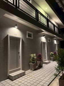 a building with potted plants on the side of it at Sarona House 4 in Ban Thalat Choeng Thale