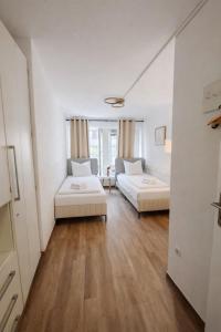 a living room with two beds and a couch at Munich Premium Guesthouse-2 in Munich +13 photos