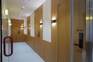 a hallway with wooden lockers in a building at Stay Ohana in Seoul