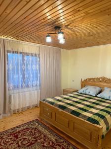 a bedroom with a bed and a large window at Floris in Myta