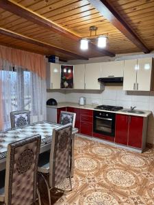 a kitchen with a table and chairs in a room at Floris in Myta