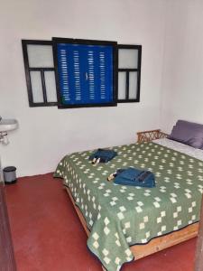 a bedroom with a bed and a blue sign on the wall at le grand atlas in Mirleft +8 photos
