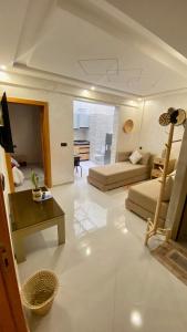 a large living room with two beds and a table at Imsouane Sea surf Camp in Imsouane