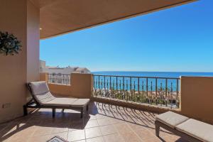 a balcony with a chair and a view of the ocean at Bella Sirena Resort Premium View Condo in Puerto Peñasco +55 photos