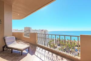 a balcony with a chair and a view of the ocean at Bella Sirena Resort Premium View Condo in Puerto Peñasco