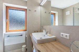 a bathroom with a sink and a mirror at PAPPELHOF Landurlaub mit Panoramablick - Motorradunterkunft Fahrradunterkunft in Bad Bellingen +115 photos