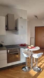 a kitchen with a table and two stools at MINI House - 3 min dal GRA By followgreenhouserome in Rome