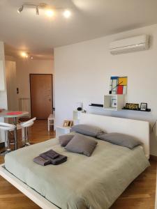 a bedroom with a large bed with two pillows on it at MINI House - 3 min dal GRA By followgreenhouserome in Rome