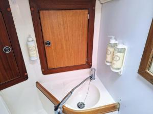 een badkamer met een houten kast en een wastafel bij Sleep on a Sailboat in Lisbon a unique stay in Lissabon +34 foto's