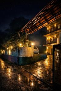 a car parked in a parking lot at night at Rivera Holiday Home in Vythiri