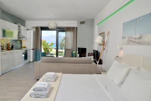 a living room with two beds and a couch at Seacret Apartments in Selianitika