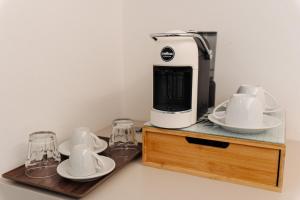 a coffee maker sitting on top of a wooden stand at Le camere in città in La Spezia +38 photos