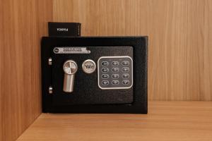 a remote control and a calculator in a black box at Le camere in città in La Spezia