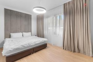 a bedroom with a bed and a large window at Apartament 1 C4 Grand Chalet Poiana Brasov in Braşov
