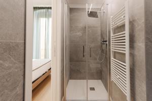 a bathroom with a shower with a glass door at Le camere in città in La Spezia