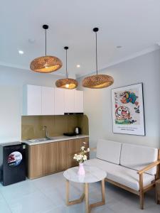 a living room with a couch and a table at Hanique Cafe and Stay in Hanoi