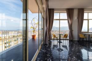 a room with a table and chairs and windows at Skyline Boutique Hotel in Palermo