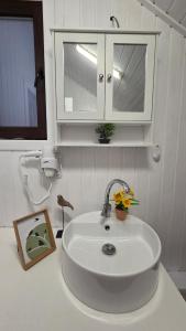 un lavandino bianco in bagno con armadio di The HIDE - Loftette a Ploieşti