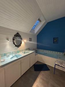 a bathroom with two sinks and a tub and a mirror at PORTSALL - La Demeure de Tréompan in Ploudalmézeau +10 photos