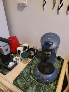 a blue blender sitting on top of a table at À la campagne, studio 25M2-pour 2p, CALME, wifi, jardin, parking in Yèvres