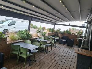 a restaurant with tables and chairs on a deck at Villa Raphaëlle #1 Centre ville avec parking in Le Havre +46 photos