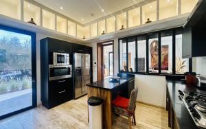 a kitchen with black cabinets and a counter top at Villa Sbaa Marrakech in Marrakesh