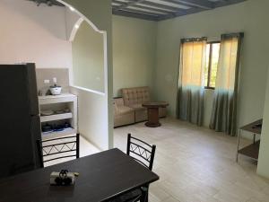 a living room with a table and a couch at Cabinas Entre Playas in Huacas