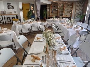 a room with tables and chairs with white tablecloths at Villa Raphaëlle #1 Centre ville avec parking in Le Havre