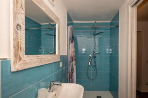 a bathroom with a shower with a toilet and a sink at Guest House - Appusentu in Castelsardo
