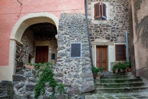 a stone building with stairs leading up to two entrances at Guest House - Appusentu in Castelsardo +32 photos