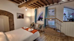 a hotel room with a bed and a staircase at La Casetta di Cri in Todi