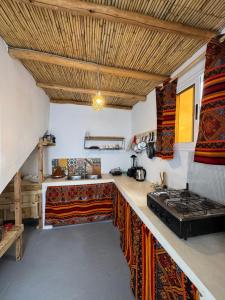 a kitchen with a counter with a stove in it at Atlantic refuge rooms in Essaouira +57 photos