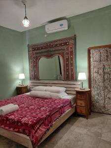 En eller flere senge i et værelse på Ameli Bed & Breakfast