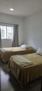 two beds sitting next to each other in a room at Nuestra Casa en Paso in Paso de la Patria +30 photos