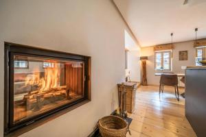 a living room with a fireplace in the wall at LA FERME D'AGATHE in Abondance