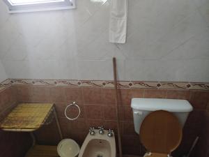 a bathroom with a toilet and a urinal and a sink at Solares LOFT in Mina Clavero +9 photos