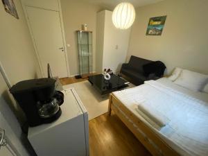 a bedroom with a bed and a living room at Private Room in Uppsala in Uppsala