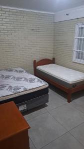 En eller flere senge i et værelse på Casa Fávero - Rua Peri